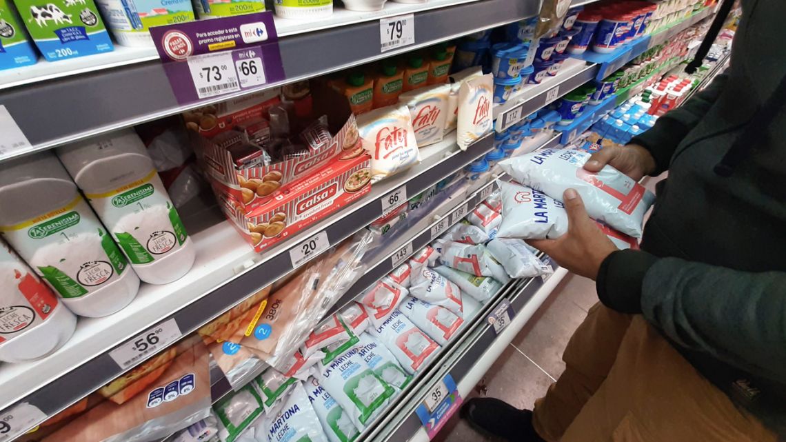 A shopper checks items at a supermarket.