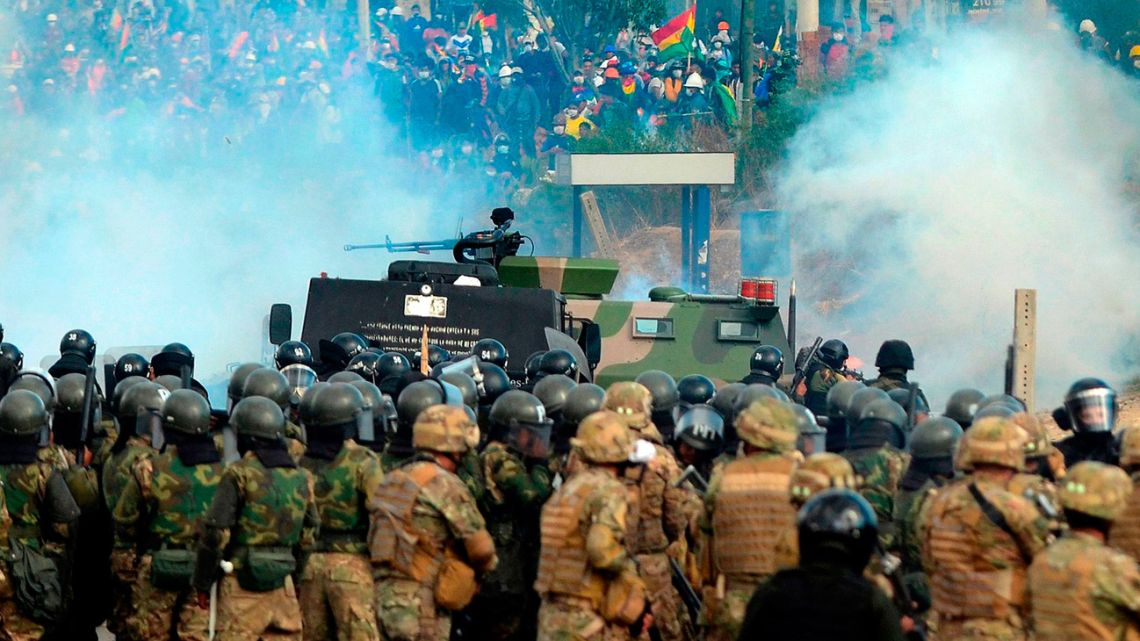 The military watch on as protesters demonstrate in Bolivia.