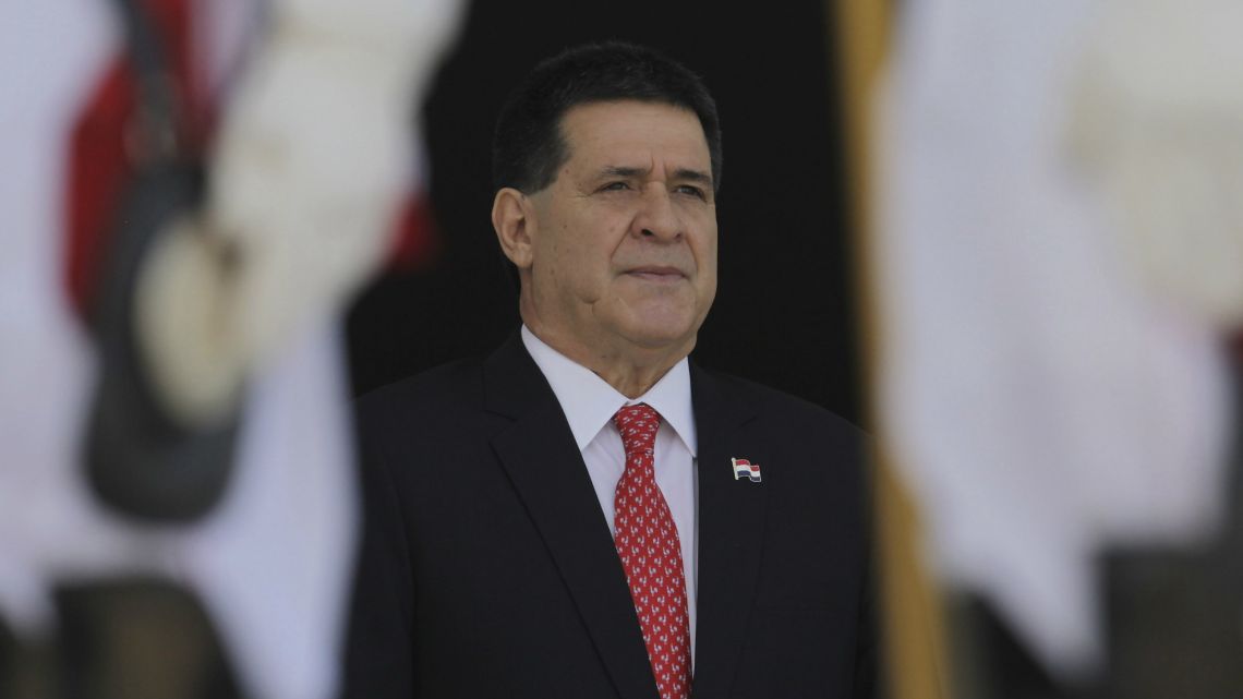 In this August 21, 2017 file photo, then Paraguay's President Horacio Cartes stands for the playing of his country's national anthem during a welcome ceremony at the Planalto Presidential Palace, in Brasilia, Brazil.