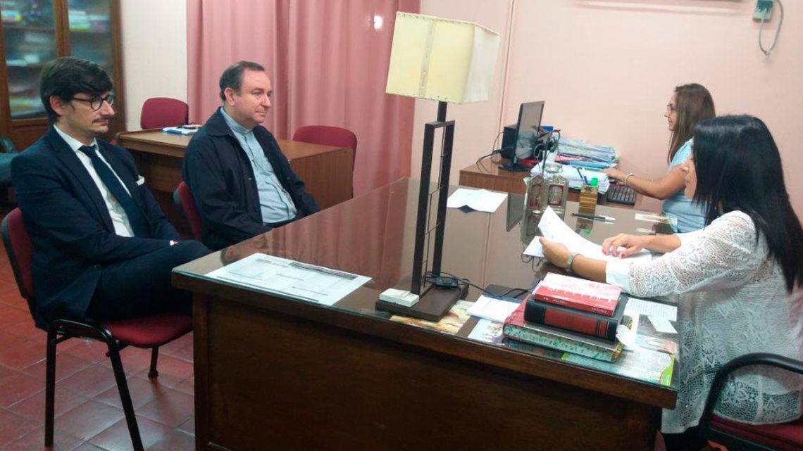 In this handout photo provided by Salta's government Judicial Branch Press Office, Argentine bishop Gustavo Zanchetta, second from left, a cleric close to Pope Francis, appears alongside his lawyer, Javier Belda Iniesta, at a judicial hearing in Orán, in the northwestern province of Salta, on Wednesday, November 27, 2019. Zanchetta was notified by members of the court that he will be put on trial for alleged abuses against two former seminarians.