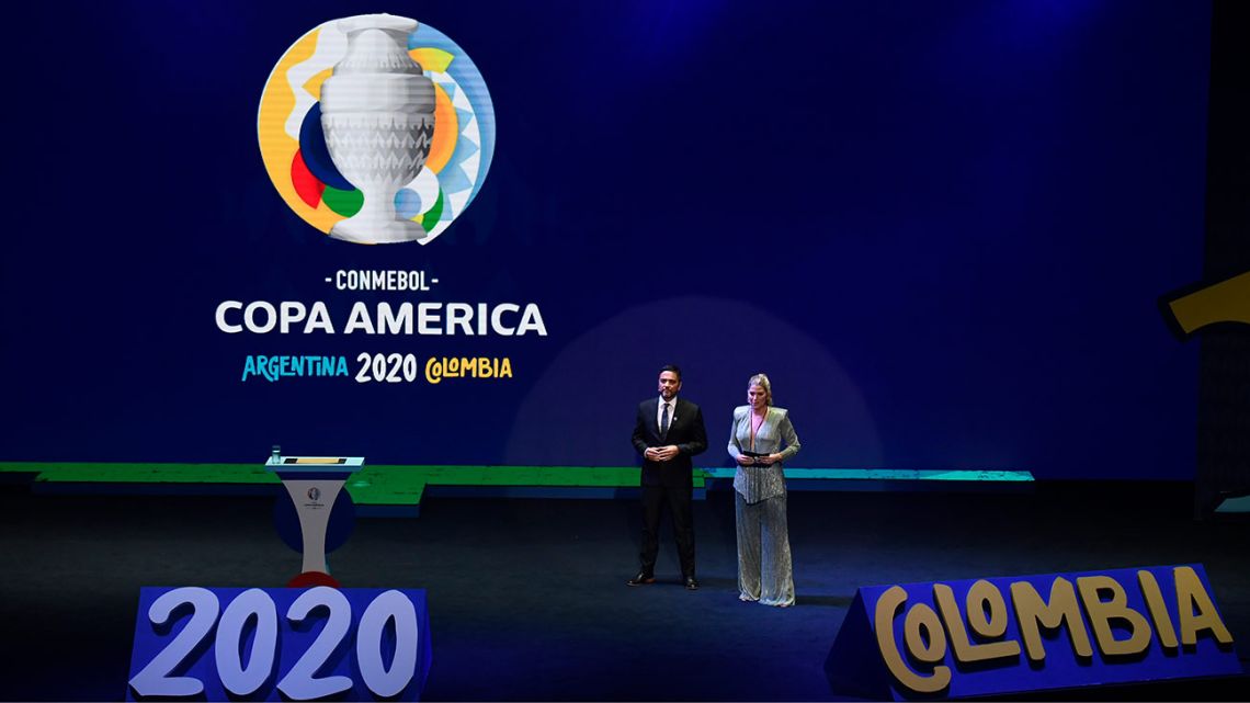Sports journalists Andrea Guerrero from Colombia and Juan José Buscaglia from Argentina present the draw of the Copa América 2020 football tournament at the Convention Centre in Cartagena, Colombia, on December 3, 2019. The Copa América 2020 football tournament will be hosted jointly by Argentina and Colombia next year, from June 12 to July 12. Asian champions Qatar and previous winner Australia will participate as invited guest teams.