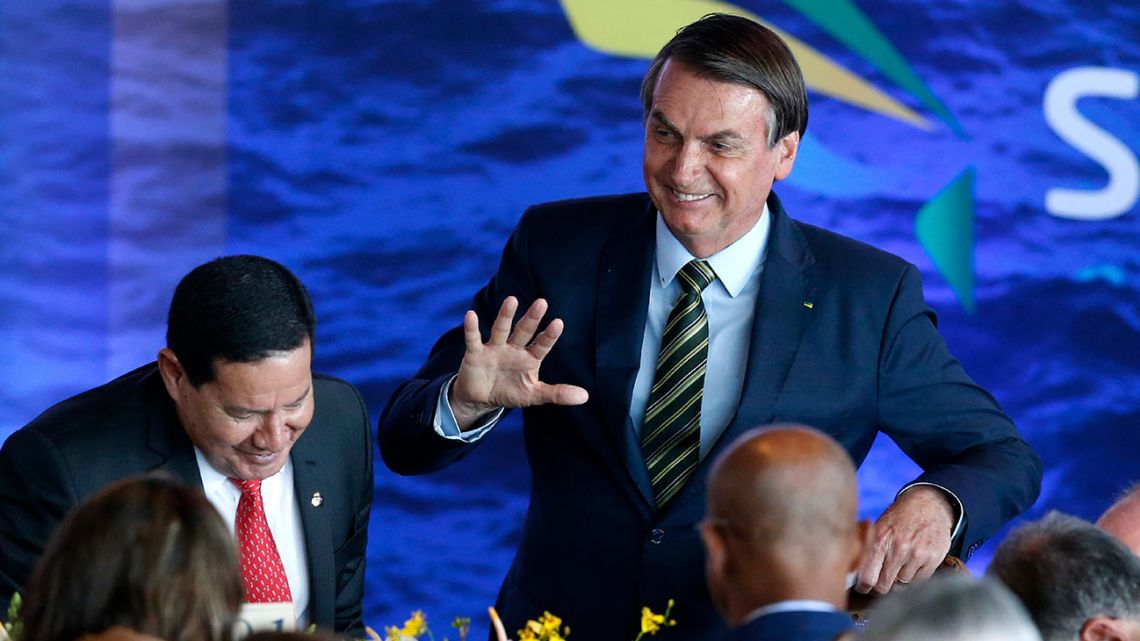 Brazil's President Jair Bolsonaro greets attendees during a lunch with Armed Forces General Officers in Brasilia, Brazil, Monday, December 9, 2019.