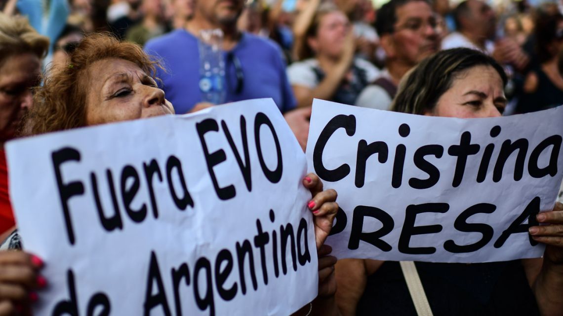 Opponents of President Alberto Fernández protest against his government and new laws with signs reading "Evo out of Argentina" and "Cristina in jail", referring to Bolivian ex-president Evo Morales and Vice-President Cristina Fernández de Kirchner, outside Congress in Buenos Aires, on December 18, 2019. 