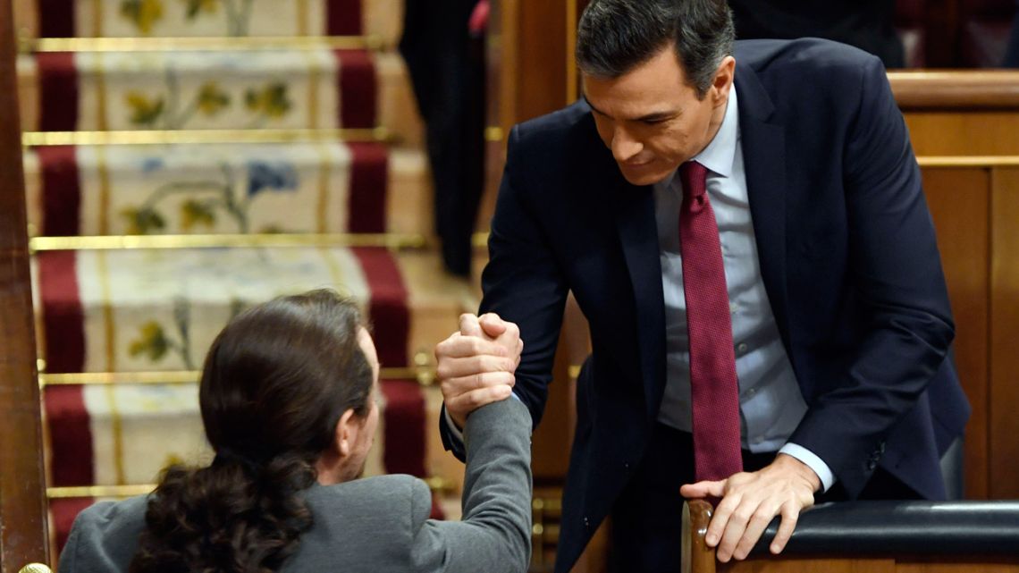 Podemos leader, Pablo Iglesias (left), shakes hands with Spanish Prime Minister, socialist Pedro Sánchez, during a parliamentary vote to elect a premier at the Spanish Congress in Madrid.