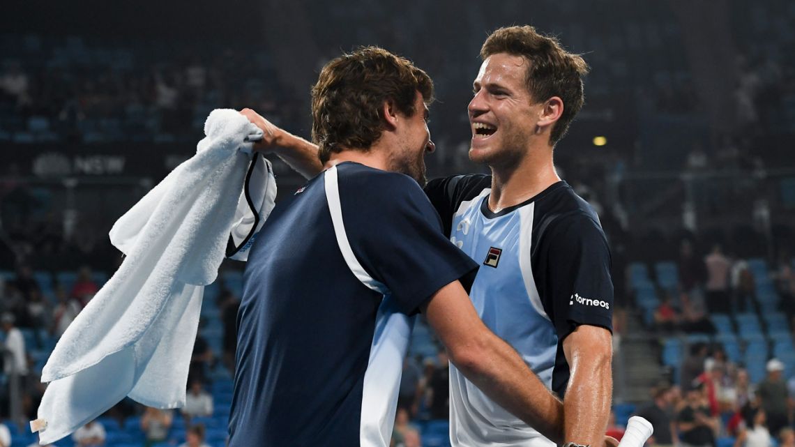 Diego Schwartzman of Argentina (right) celebrates victory with teammate Guido Pella (left) after his men's singles match against Borna Coric of Croatia at the ATP Cup tennis tournament in Sydney on January 8, 2020.