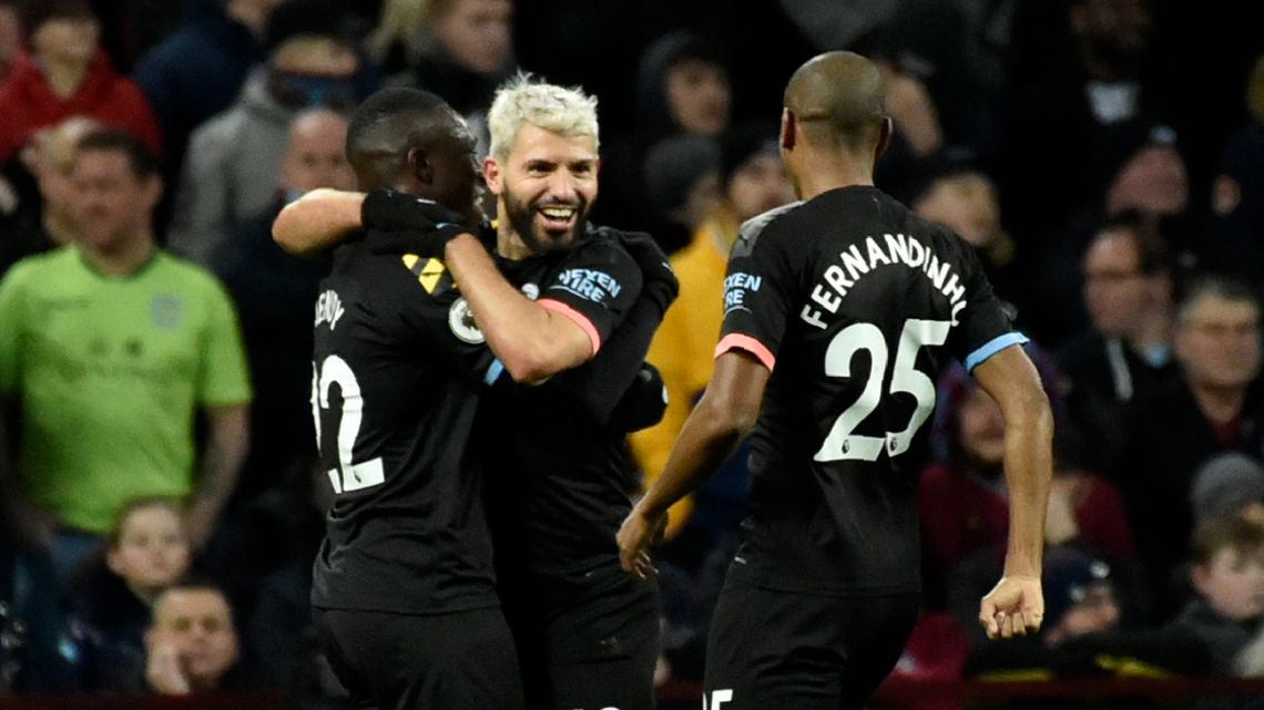 Manchester City's Sergio Agüero celebrates with teammates after scoring his side's third goal during the English Premier League match between Aston Villa and Manchester City at Villa Park.