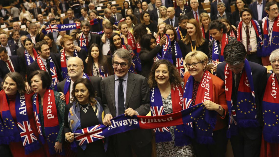 European Parliament President David Sassoli, center, stands with other British MEP's and members of the political group Socialist and Democrats as they participate in a ceremony prior to the vote on the UK's withdrawal from the EU at the European Parliament in Brussels.