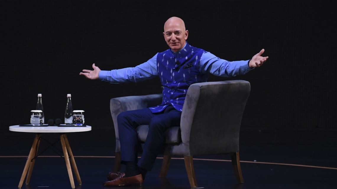 In this photo taken on January 14, 2020 CEO of Amazon Jeff Bezos (R) gestures during the Amazon's annual Smbhav event in New Delhi