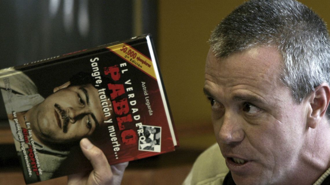  Jhon Jairo Velasquez, a former hit man for Pablo Escobar, known by his nickname "Popeye," gives testimony while holding a book titled "The True Pablo, Blood, Treason, and Death."