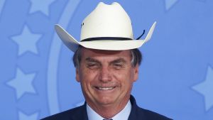 Brazil's President Jair Bolsonaro gestures wearing a hat during a ceremony with singers of country music at Planalto Palace in Brasilia, Brazil, on January 29, 2020.