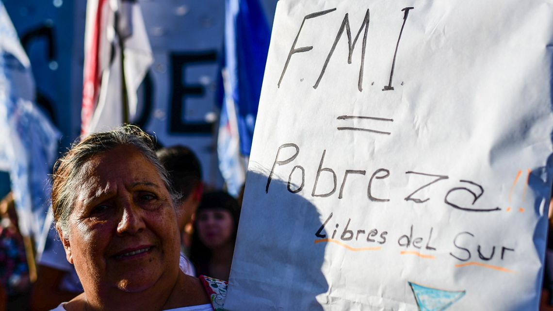 People protest against the International Monetary Fund (IMF) outside of Congress, on February 12, 2020.