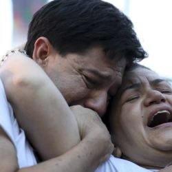 Graciela Sosa and her husband Silvino Baez mourn the death of their son Fernando Baez Sosa outside of Congress.