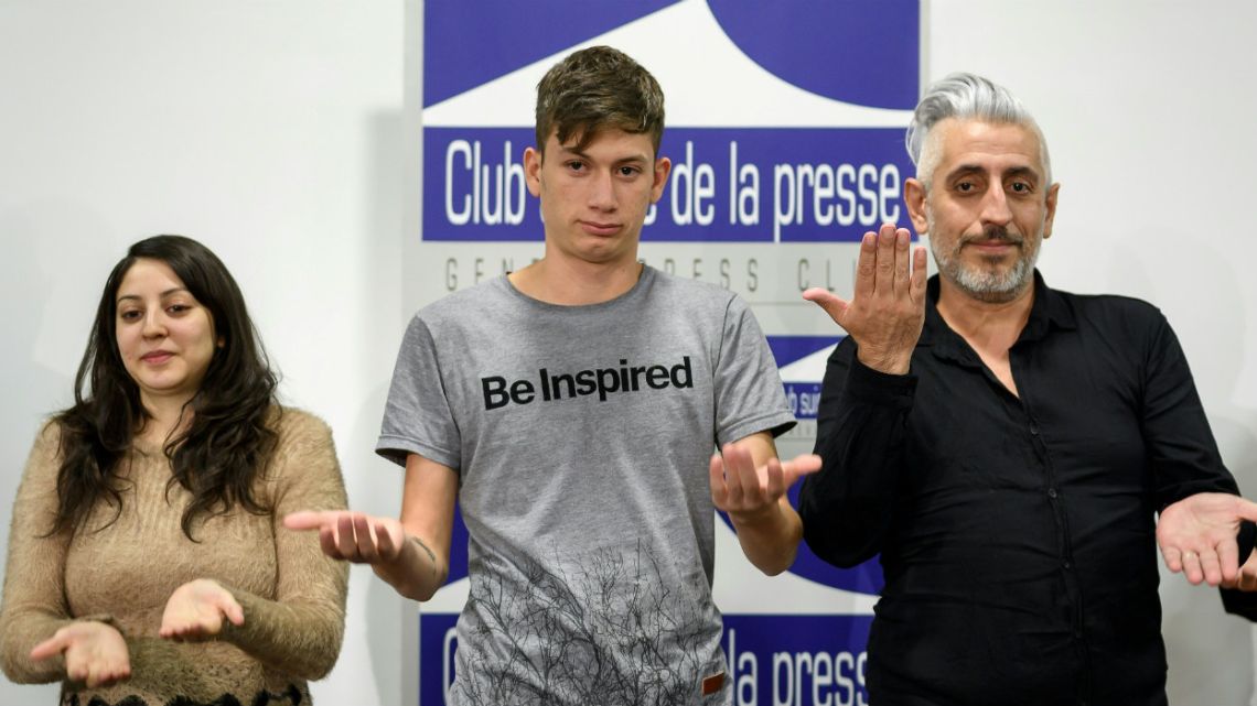 Deaf survivors of clerical sexual abuse from Argentina, (from L) Claudia Labeguerie, Ezequiel Villalongo and Daniel Oscar Sgardelis gesture during a press conference at the Geneva Press Club.