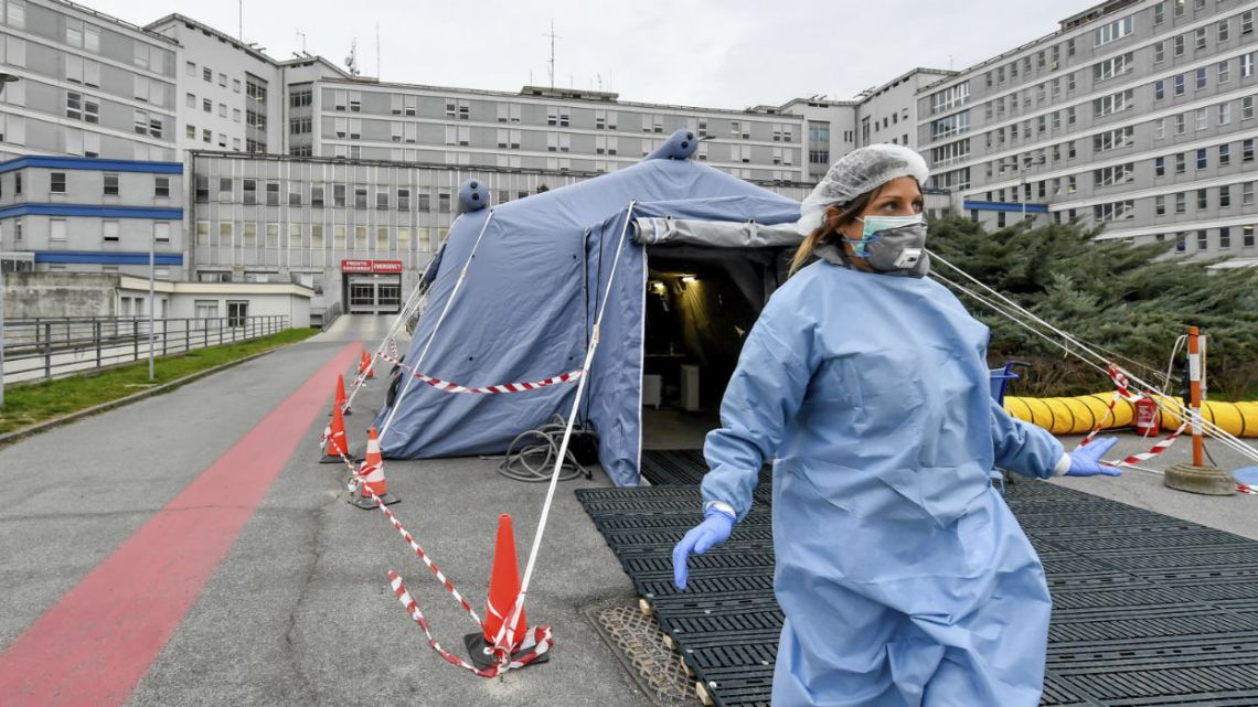 A paramedic walks out of a tent that was set up in front of the emergency ward of the Cremona hospital, northern Italy.