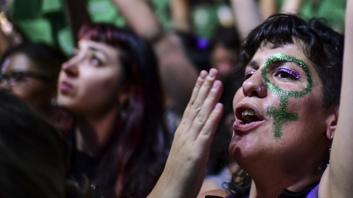 Thousands of women hold green scarves demanding the the decriminalization of abortion as they protest at Argentina's National Congress.