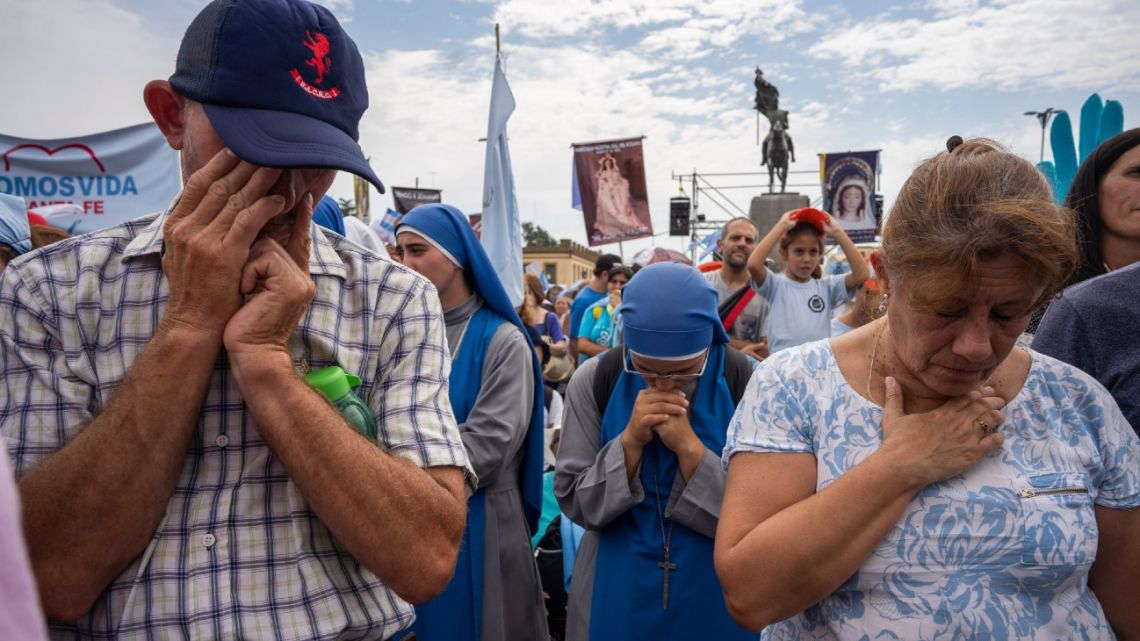 People pray during an anti-abortion Mass outside of the Basilica of Lujan, some 80 kilometers west of Buenos Aires, Argentina, on Sunday, March 8, 2020.
