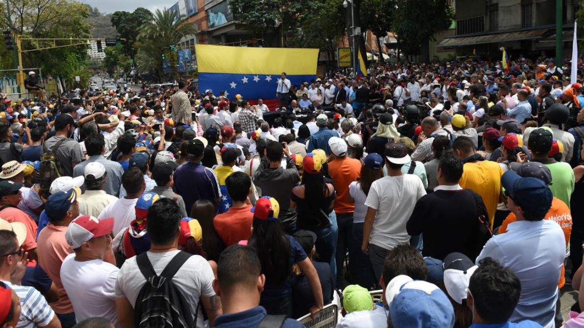 Supporters of Venezuelan opposition leader Juan Guaidó attend a street meeting within a demonstration heading to the National Assembly.