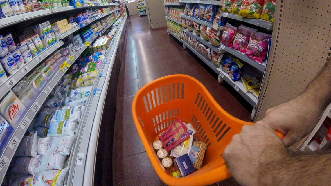 A shopper fills up his basket at a supermarket in Buenos Aires.