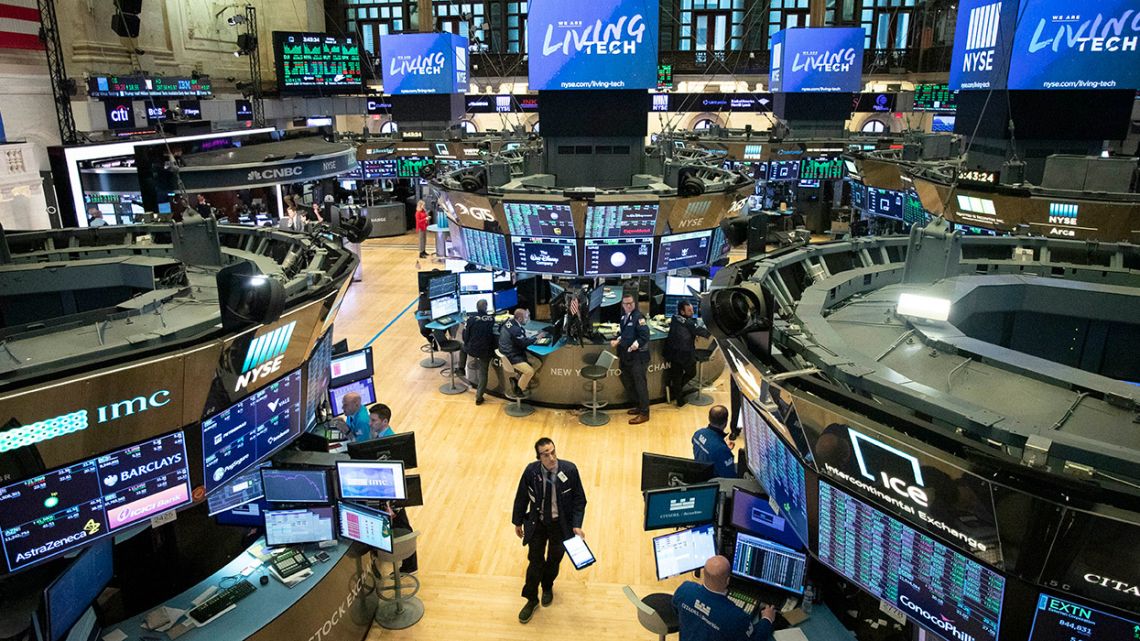 A trader walks on the floor of the New York Stock Exchange, March 13.