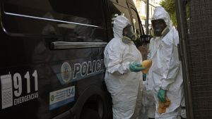 Police desinfect a van at a hotel in Buenos Aires on March 16, 2020.