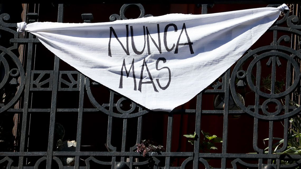 A white handkerchief with the message "Nunca más" hangs from a balcony in Buenos Aires, Tuesday, March 24, 2020. 