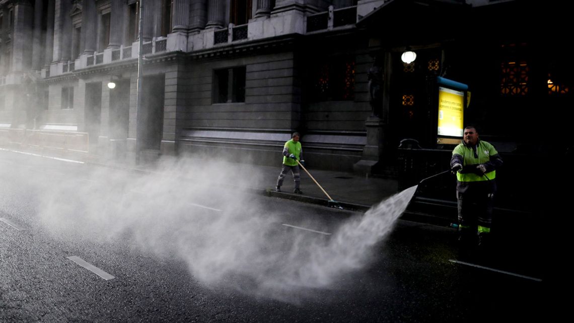 A worker disinfects the street outside Congress during the government-ordered lockdown to curb the spread of the new coronavirus.