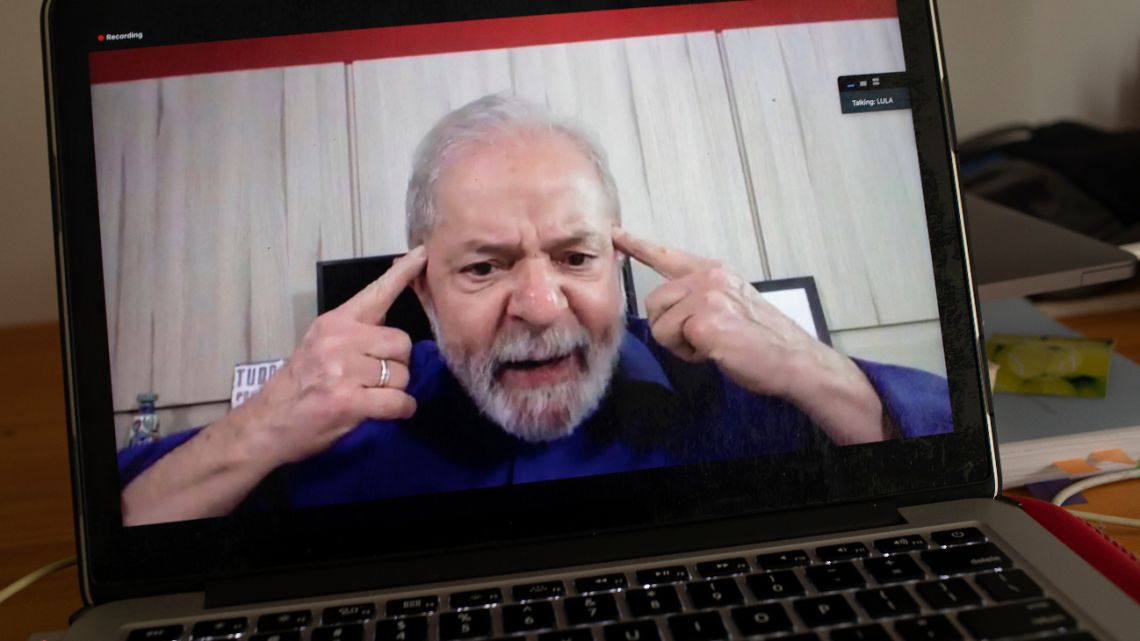 Brazil's former President Luiz Inacio Lula da Silva speaks from his home in Sao Paulo during an interview with The Associated Press via a cloud-based video conferencing service, as seen from a laptop in Rio de Janeiro, Brazil, Wednesday, April 8, 2020. 