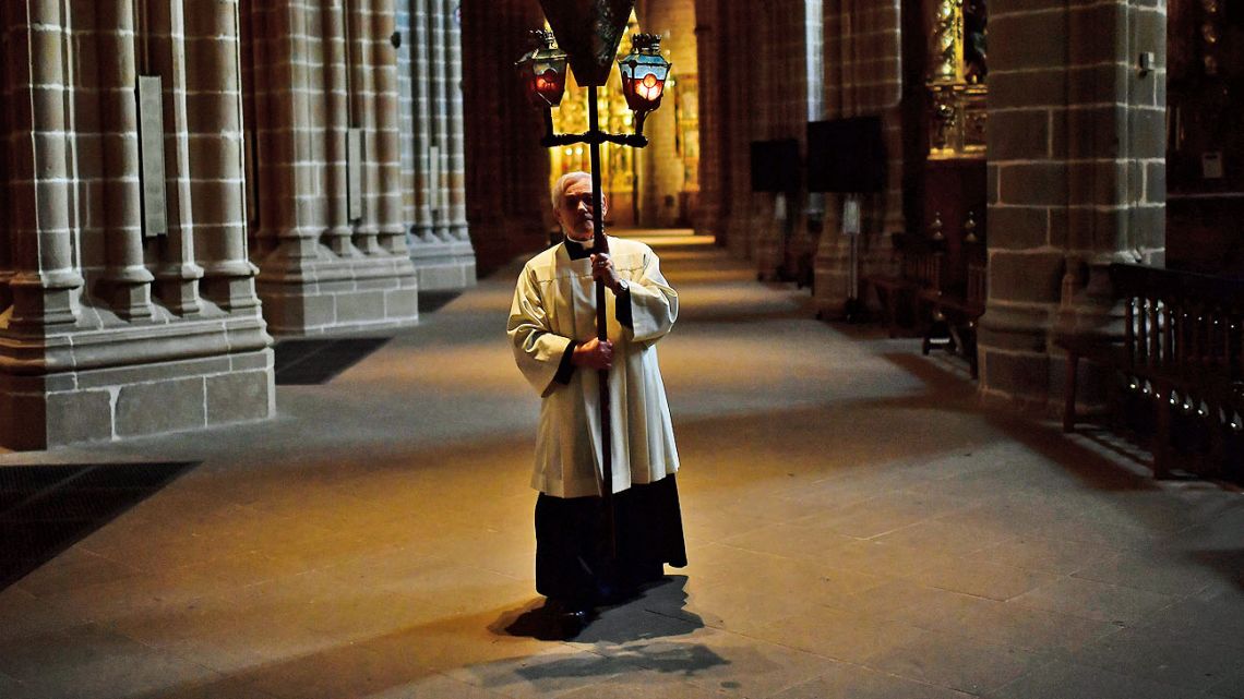 A priest walks during a Stations of the Cross, in an empty Santa Maria Cathedral during Good Friday, after celebrations and services were cancelled due to the outbreak of coronavirus, in Pamplona, northern Spain.