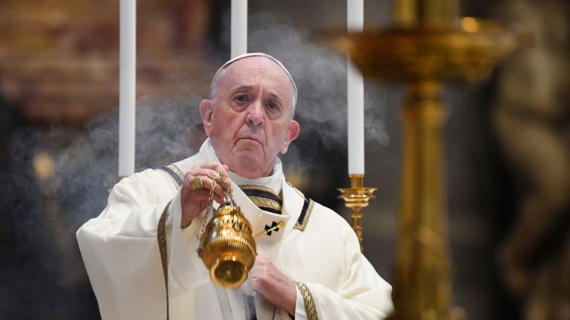 Pope Francis spreads incense at the start of Easter Sunday Mass, inside an empty St. Peter's Basilica at the Vatican, Sunday, April 12, 2020. 
