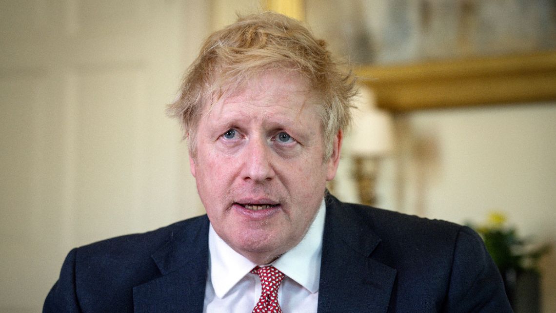 A handout image released by 10 Downing Street, shows Britain's Prime Minister Boris Johnson as he delivers a television address after returning to 10 Downing Street after being discharged from St Thomas' Hospital, in central London on April 12, 2020.