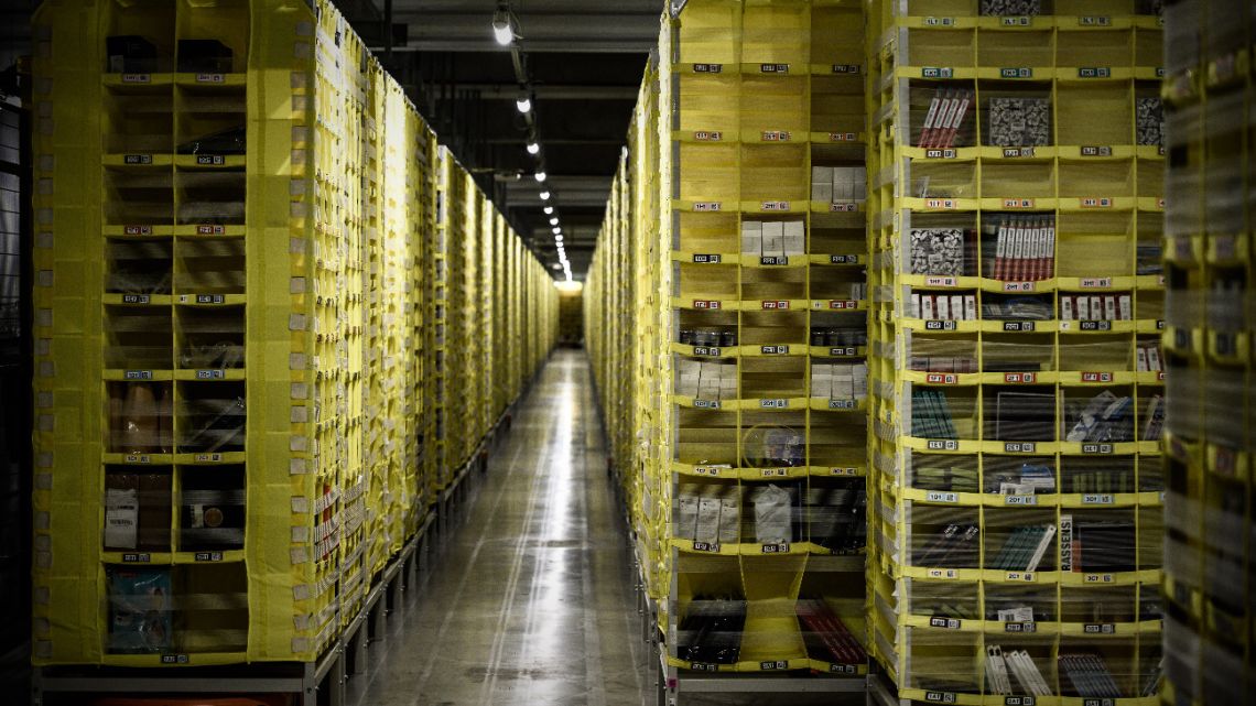 This file photo taken on October 22, 2019 shows an Amazon warehouse, part of mobile robotic fulfilment systems also known as 'Amazon robotics', in Bretigny-sur-Orge, some 30kms south of Paris.