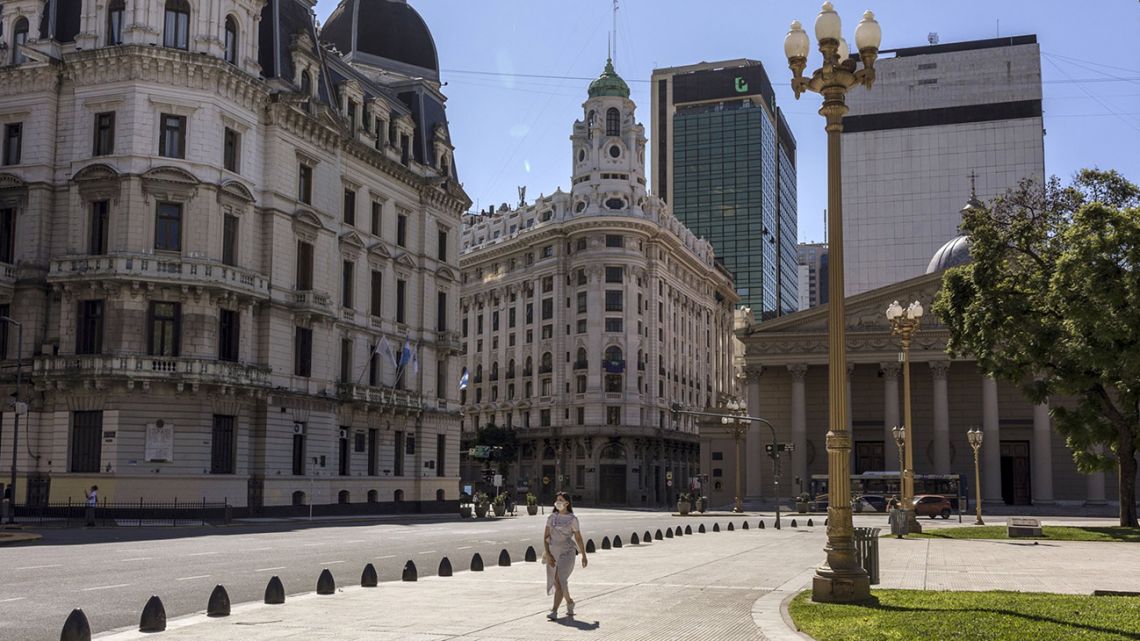 A woman walks on the outskirts of the Plaza de Mayo in Buenos Aires.