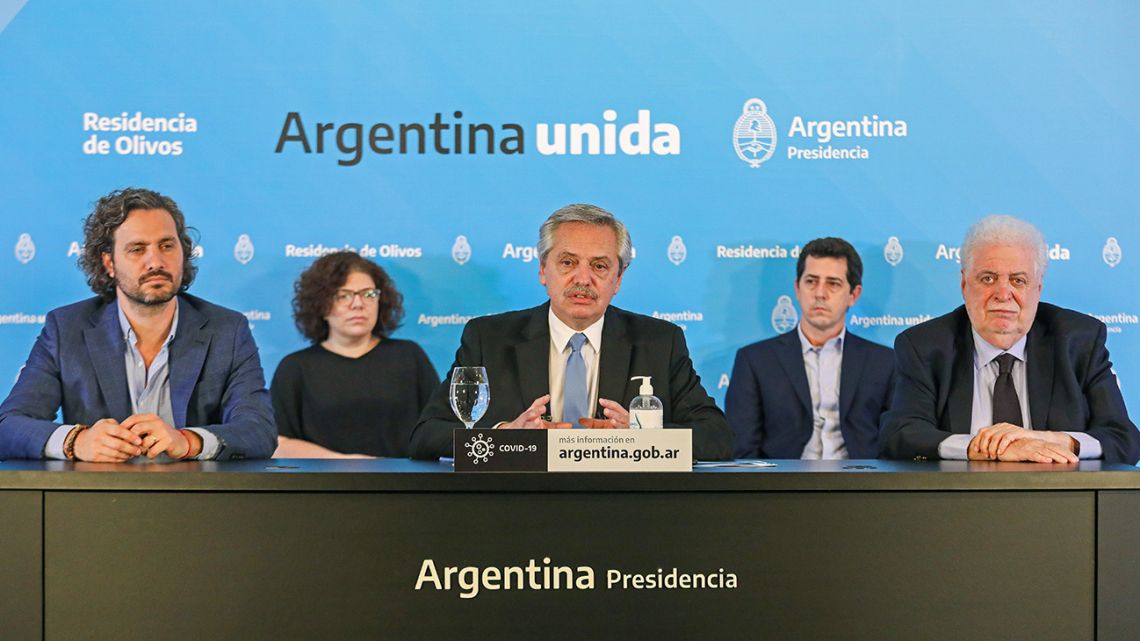Handout picture released by the Presidency showing President Alberto Fernández (centre), flanked by his Health Minister Ginés González García (right) and Cabinet Chief Santiago Cafiero (left), as he announces the extension of Argentina's "preventative and compulsory" lockdown until May 10.