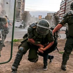La policía antidisturbios chilena agarró a un manifestante durante una protesta contra el gobierno del presidente chileno Sebastián Piñera, en Santiago, el 27 de abril de 2020. (Foto de JAVIER TORRES / AFP) | Foto:AFP