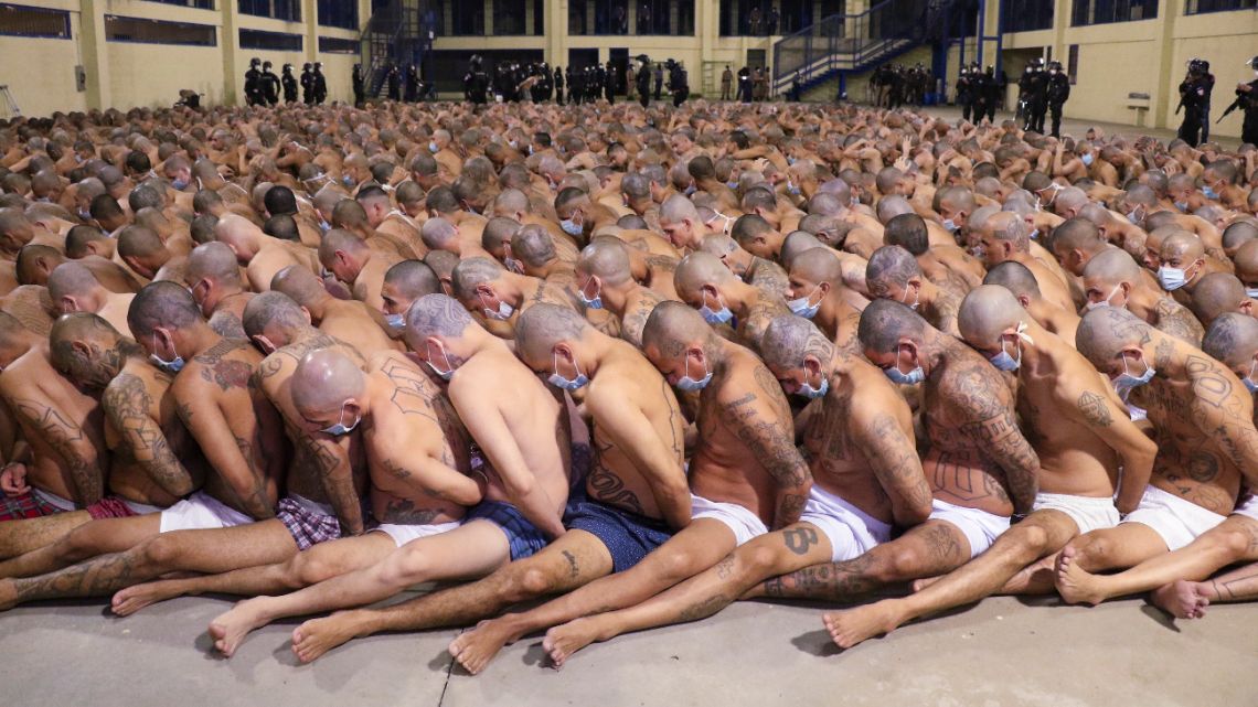 In this photo released by the El Salvador Presidency Press Office, inmates are lined up during a security operation under the watch of police at the Izalco prison in San Salvador, El Salvador, Saturday, April 25, 2020. 