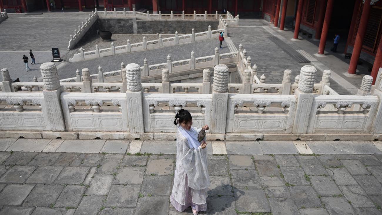 Los visitantes usan mascarillas como medida preventiva contra el Coronavirus, mientras caminan por la Ciudad Prohibida, el antiguo palacio de los emperadores de China.