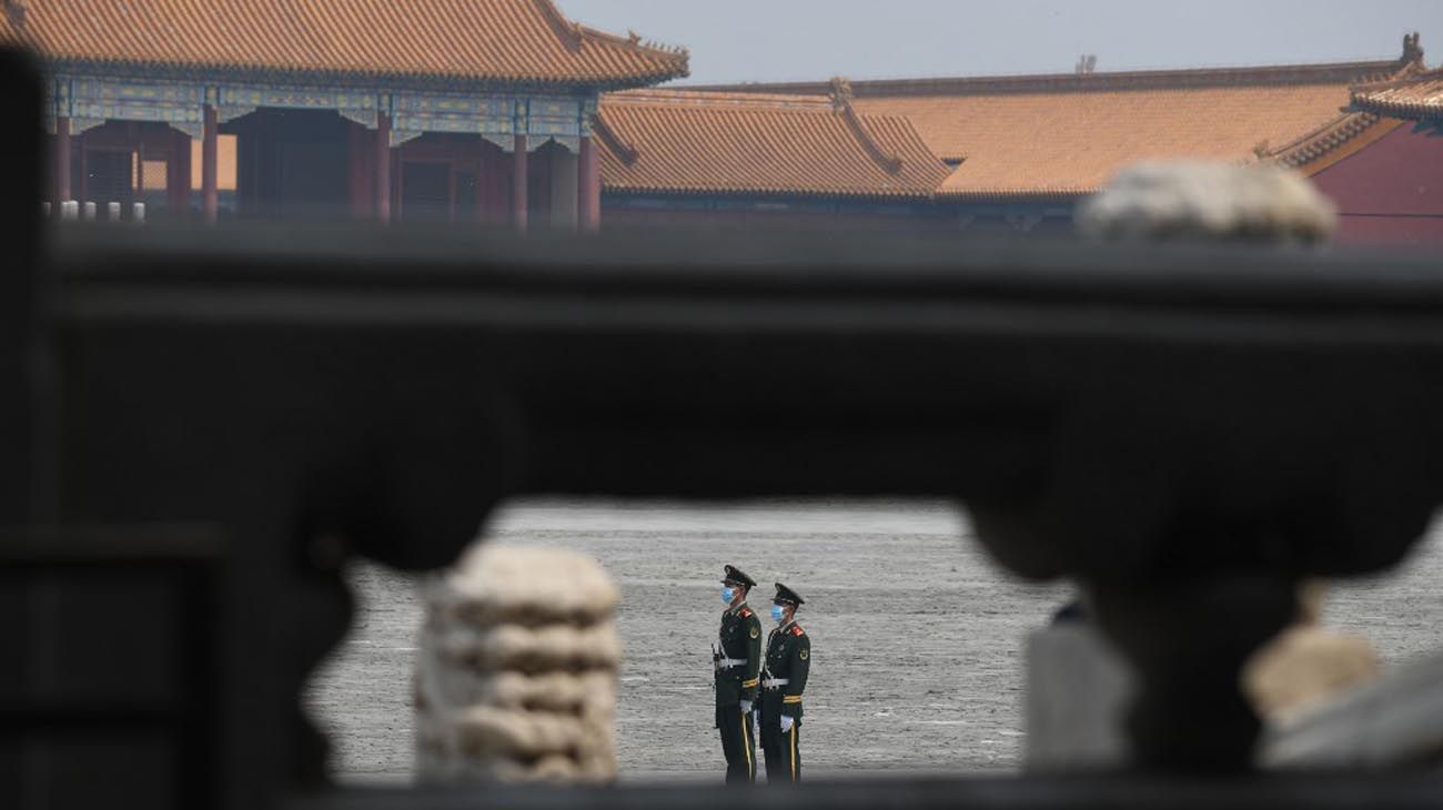 Los visitantes usan mascarillas como medida preventiva contra el Coronavirus, mientras caminan por la Ciudad Prohibida, el antiguo palacio de los emperadores de China.