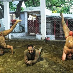 Los luchadores aficionados practican en un pozo de barro tradicional en Calcuta el 9 de mayo de 2020. (Foto de Dibyangshu SARKAR / AFP) | Foto:AFP