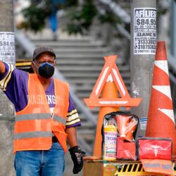 Un hombre que vende letreros de la calle usa una máscara facial como medida preventiva contra la propagación del coronavirus COVID-19, en Bogotá, el 11 de mayo de 2020. (Foto por Raúl ARBOLEDA / AFP) | Foto:AFP