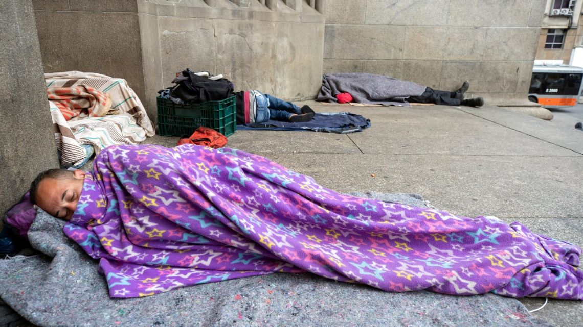 Homeless people sleep outside the Cathedral amid the spread of the new coronavirus in Sao Paulo, Brazil, Thursday, May 7, 2020.