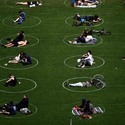 Se ve a personas practicando distanciamiento social en círculos blancos en Domino Park, durante la pandemia de Covid-19 el 17 de mayo de 2020 en el distrito de Brooklyn de la ciudad de Nueva York. (Foto de Johannes EISELE / AFP) | Foto:AFP