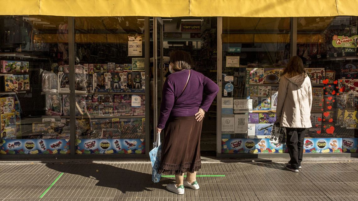 Shoppers line up alongside a newly re-opened toyshop in Buenos Aires.