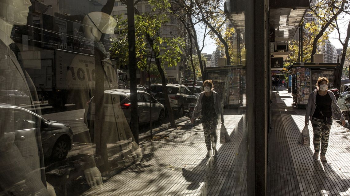 A pedestrian wearing a protective mask passes by a store in the Barrio Norte neighbourhood of Buenos Aires.