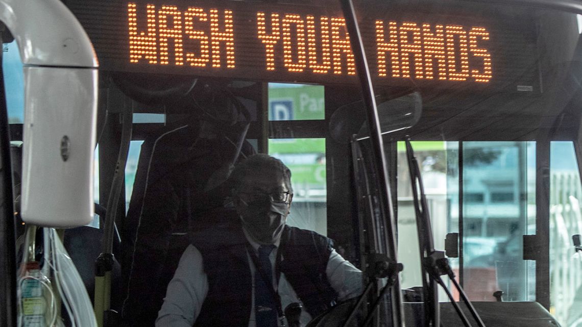A public transport driver wears a face mask as a preventive measure against the spread of the novel coronavirus, Covid-19, at El Dorado international airport in Bogotá on May 18, 2020. 