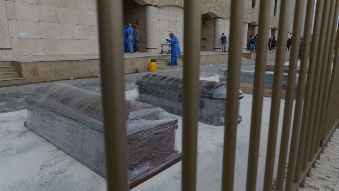Coffins of coronavirus victims wait to be buried at a cemetery in Guayaquil on April 3.
