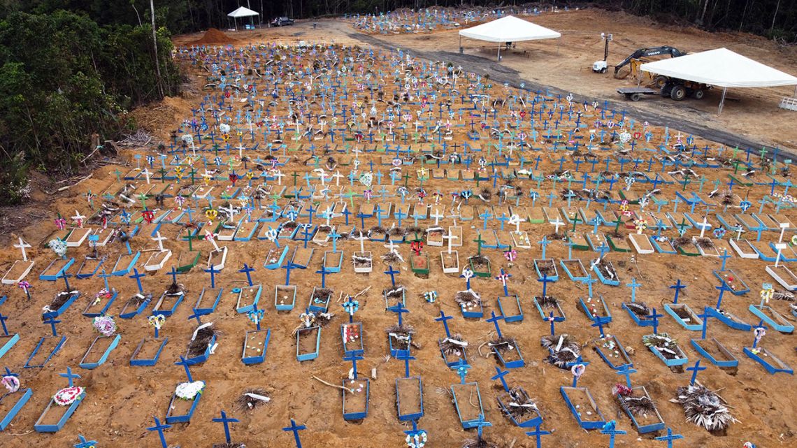 Aerial view of an area at the Nossa Senhora Aparecida cemetery where new graves have been dug in Manaus, Brazil, on May 22, 2020 amid the novel Covid-19 coronavirus pandemic. Brazil, the hardest-hit Latin American country in the coronavirus pandemic, has surpassed 20,000 deaths, according to Brazil's Ministry of Health 