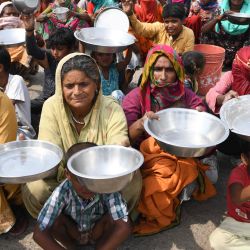 Los trabajadores migrantes y sus familiares de Maharastra sostienen utensilios de cocina mientras protestan contra el gobierno por la falta de alimentos en una zona de tugurios, después de que el gobierno alivió un bloqueo nacional impuesto como medida preventiva contra el coronavirus COVID-19, en las afueras de Amritsar. | Foto:NARINDER NANU / AFP.