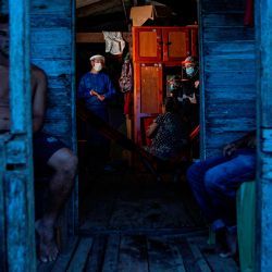 Los trabajadores de salud del gobierno evalúan a un residente de la comunidad ribereña de Roli Madeira en medio de la preocupación por la propagación del coronavirus COVID-19, en el suroeste de la isla de Marajo, en el estado de Pará, Brasil. | Foto:TARSO SARRAF / AFP
