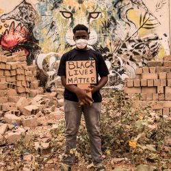Un manifestante senegalés posa para un retrato con su cartel de  | Foto:JOHN WESSELS / AFP