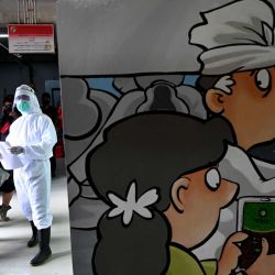 Un miembro del personal médico que usa equipo de protección dice los nombres de las personas que se someterán a la prueba del coronavirus COVID-19 en un mercado tradicional en Denpasar, en la isla turística de Indonesia, Bali. | Foto:SONNY TUMBELAKA / AFP